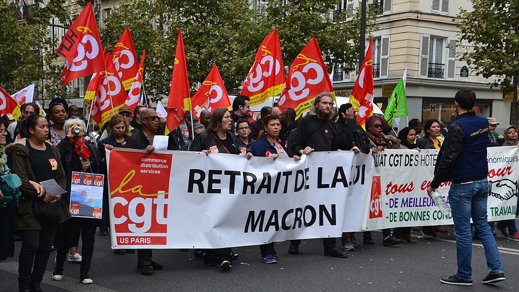 Demonstrators carrying red CGT flags and banner