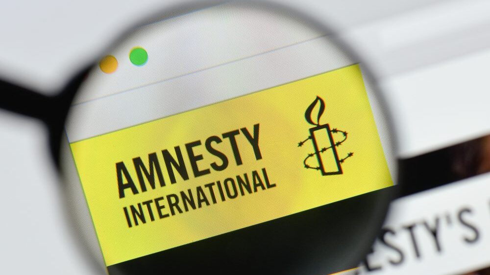 Magnifying glass over Amnesty International logo on website
