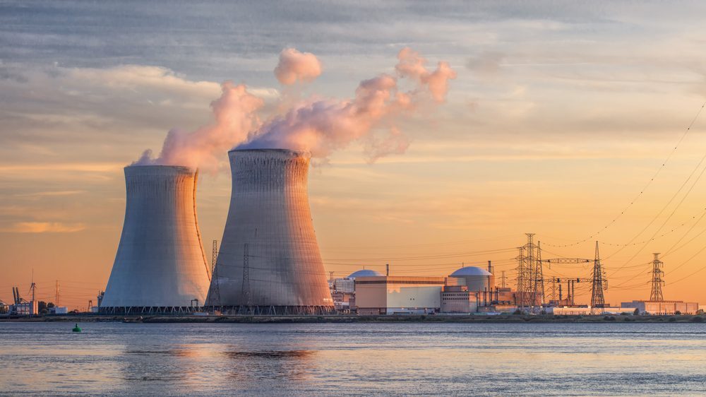 Late afternoon scene with view on riverbank with nuclear reactor Doel, Port of Antwerp, Belgium.