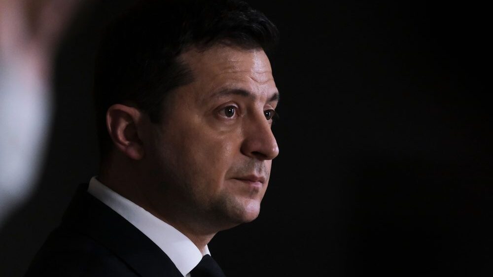 Volodymyr Zelensky profile looking right pensive expression.