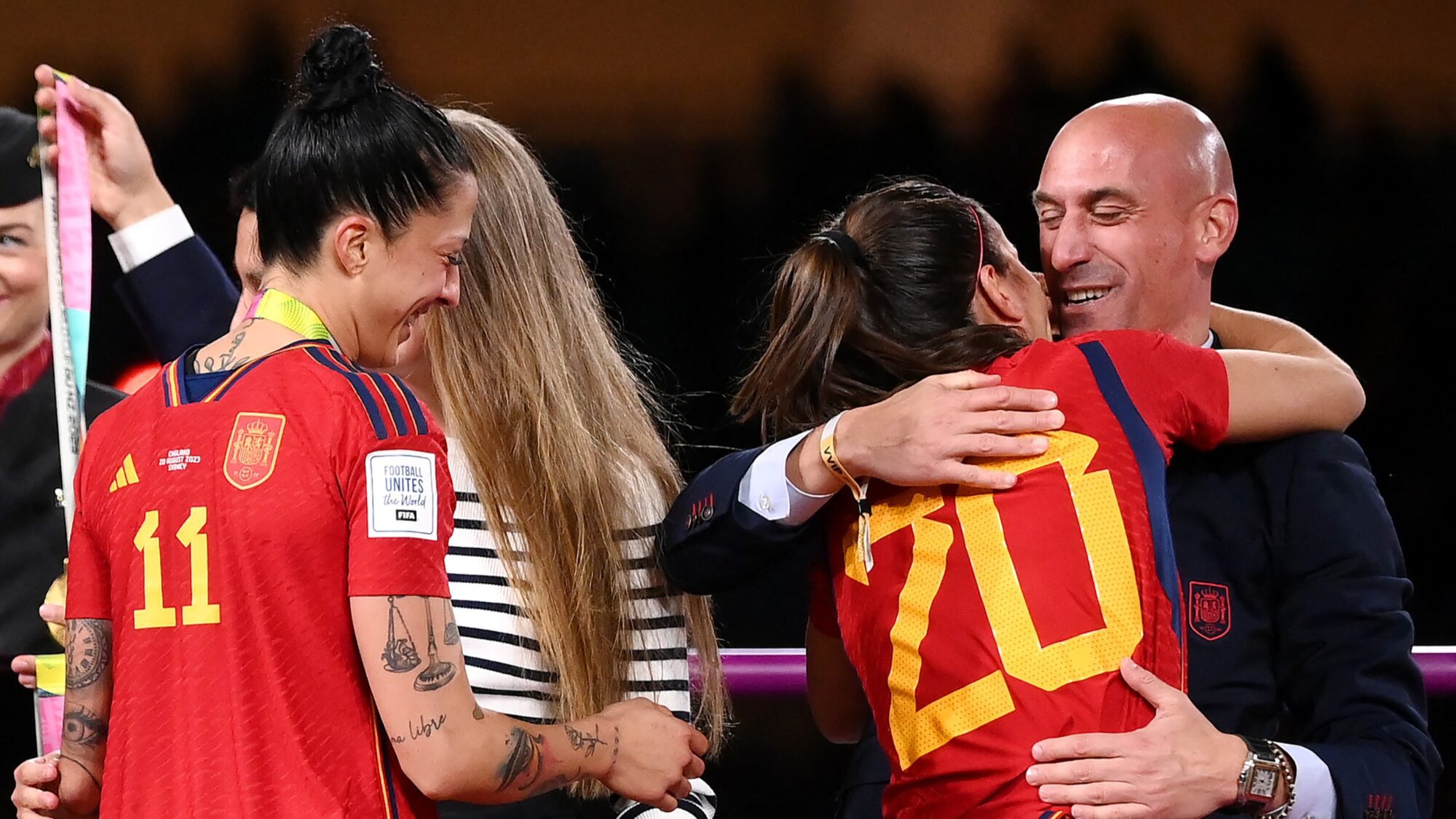 Spain's defender #20 Rocio Galvez is congratulated by President of the Royal Spanish Football Federation Luis Rubiales (R) next to Spain's Jennifer Hermoso after winning the Australia and New Zealand 2023 Women's World Cup final football match between Spain and England at Stadium Australia in Sydney on August 20, 2023.