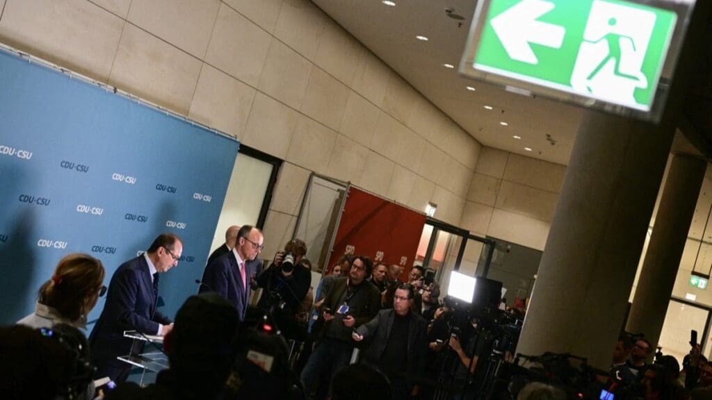 Friedrich Merz (R) and the parliamentary group leader of the Christian Social Union (CSU) party Alexander Dobrindt give a statement after a bill to restrict immigration proposed by the conservative CDU/CSU with the support of the AfD was narrowly voted down in the Bundestag in Berlin on January 31, 2025.