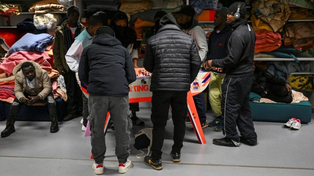 Migrants illegally occupying the Gaîté Lyrique cultural center in Paris play table football on December 11, 2025.