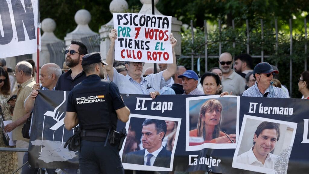 Protestors outside a Madrid court demonstrate as Begoña Gomez, wife of Spain’s Prime Minister Pedro Sanchez, is expected to appear before a magistrate in a graft probe on July 4, 2024. The sign reads “the boss, the wife, the brother”.