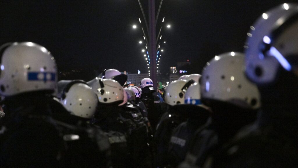 Serbian police in riot gear block a bridge during an anti-government demonstration in Belgrade