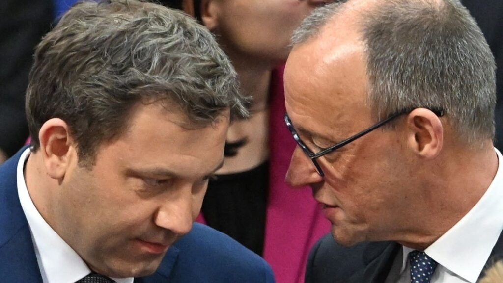 Leader of Germany's Christian Democratic Union (CDU) Friedrich Merz speaks with Chairman of the Germany's Social Democratic Party (SPD) Lars Klingbeil during the constituent session of Germany's new Bundestag (lower house of parliament) on March 25, 2025 in Berlin. 