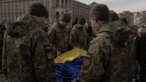 Ukrainian soldiers hold a national flag over the coffin of Vasyl Ratushnyi, a Ukrainian serviceman who served as a drone operator in "Madyar's Birds" unit and who was killed fighting Russian troops at the front, during his funeral ceremony on the Independence Square in Kyiv on March 5, 2025.