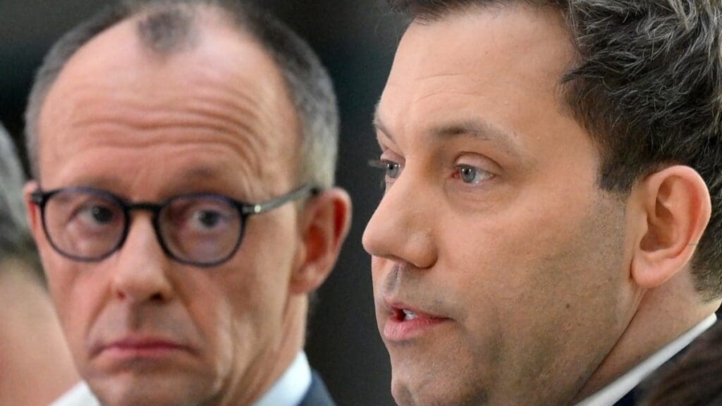 CDU leader Friedrich Merz (L) looks on as the co-leader of SPD Lars Klingbeil speaks during a joint statement in Berlin on March 8, 2025.