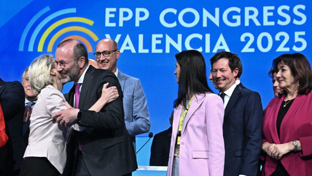 Manfred Weber (2L) embraces Ursula von der Leyen during the European People's Party congress in Valencia