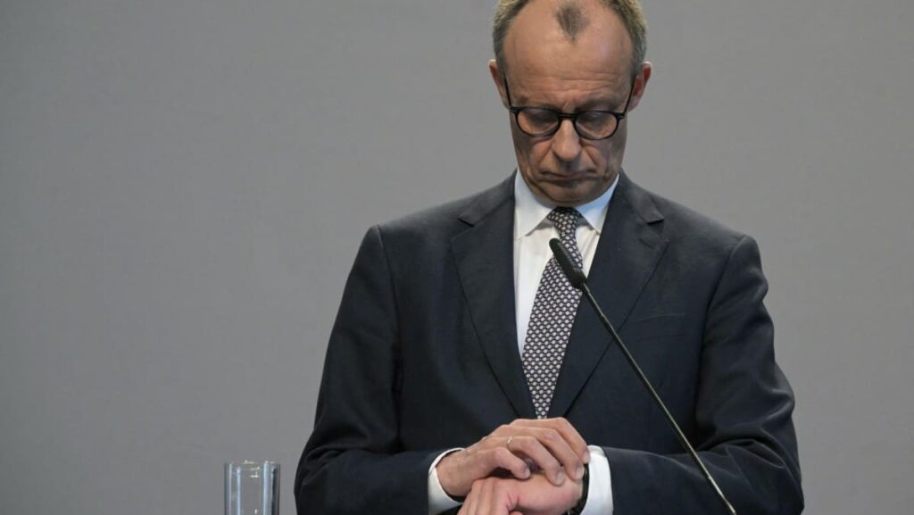 Friedrich Merz CDU looking at the time