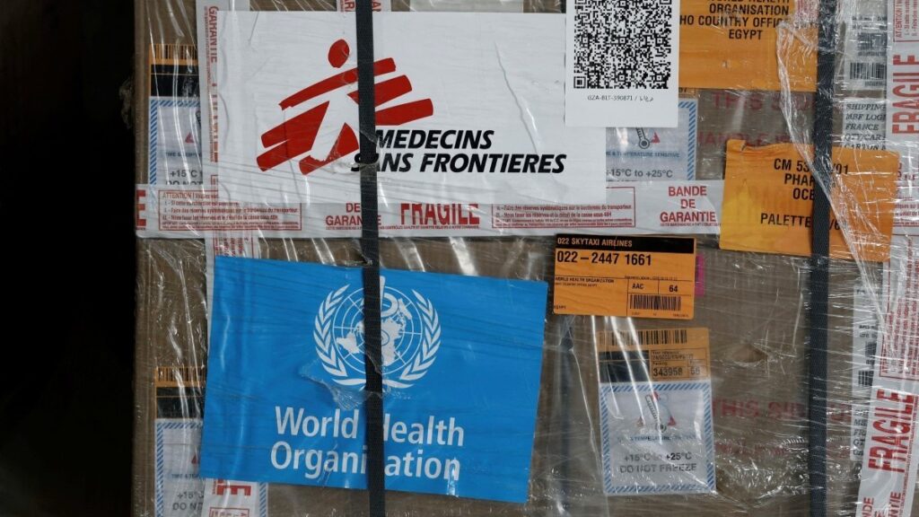 The logos of Médecins sans Frontières (MSF) and of the World Health Organization (WHO) seen on humanitarian supplies for Gaza in an Egyptian Red Crescent warehouse in El-Arish on April 8, 2025.