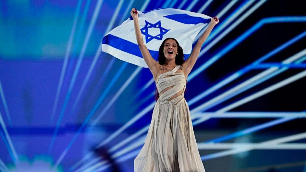 Russian Israeli singer Eden Golan representing Israel holding the flag of Israel at the start of the final of the 68th Eurovision Song Contest on May 11, 2024 in Malmö.