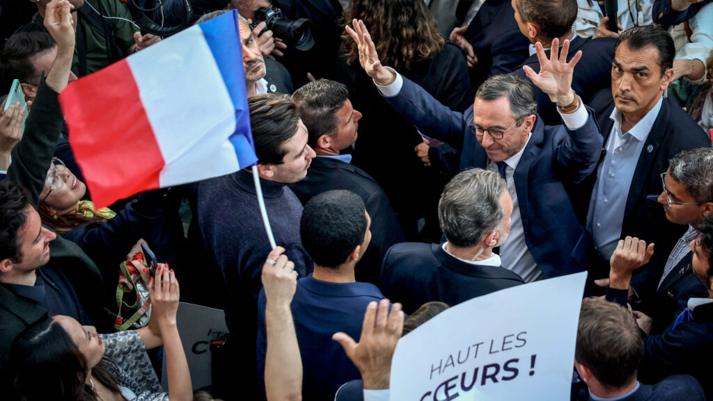 France's Interior Minister Bruno Retailleau celebrates with supporters, surrounded by reporters, as he leaves French party Les Républicains (LR) headquarters following his election as LR's president in Paris on May 18, 2025.
