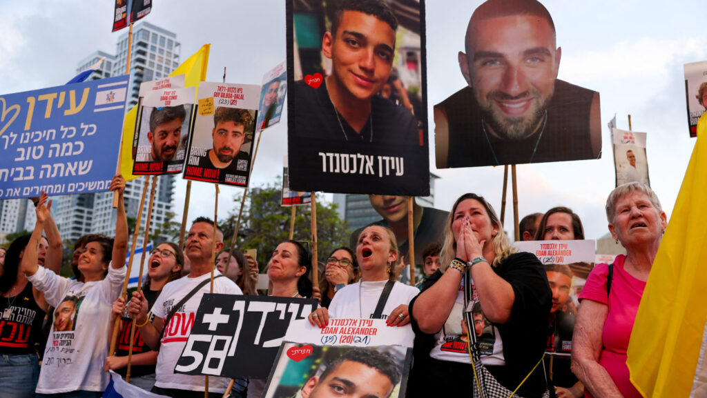 Israelis watch on a screen the release of Edan Alexander, an Israeli-American held hostage by Hamas in the Gaza Strip since October 2023, at Hostages Square in Tel Aviv on May 12, 2025.