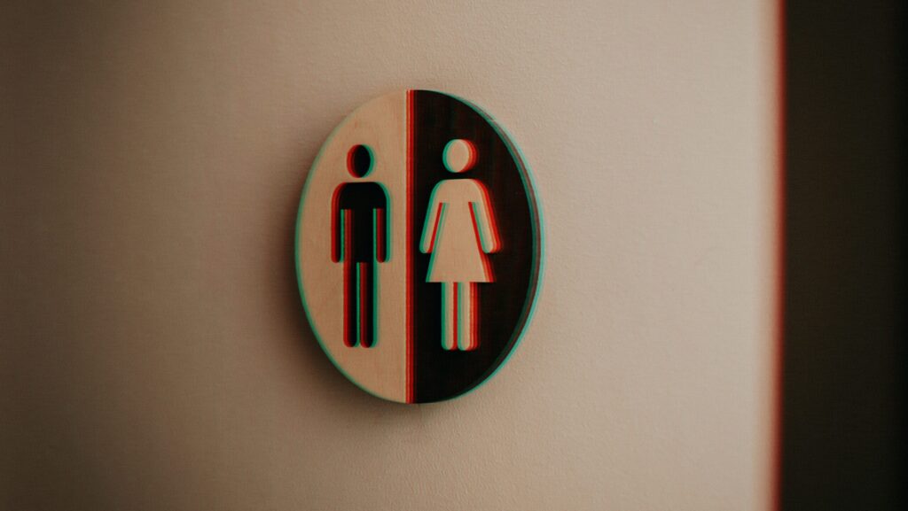 bathroom sign with male and female figure fuzzy edges signifying confusion about gender and sex
