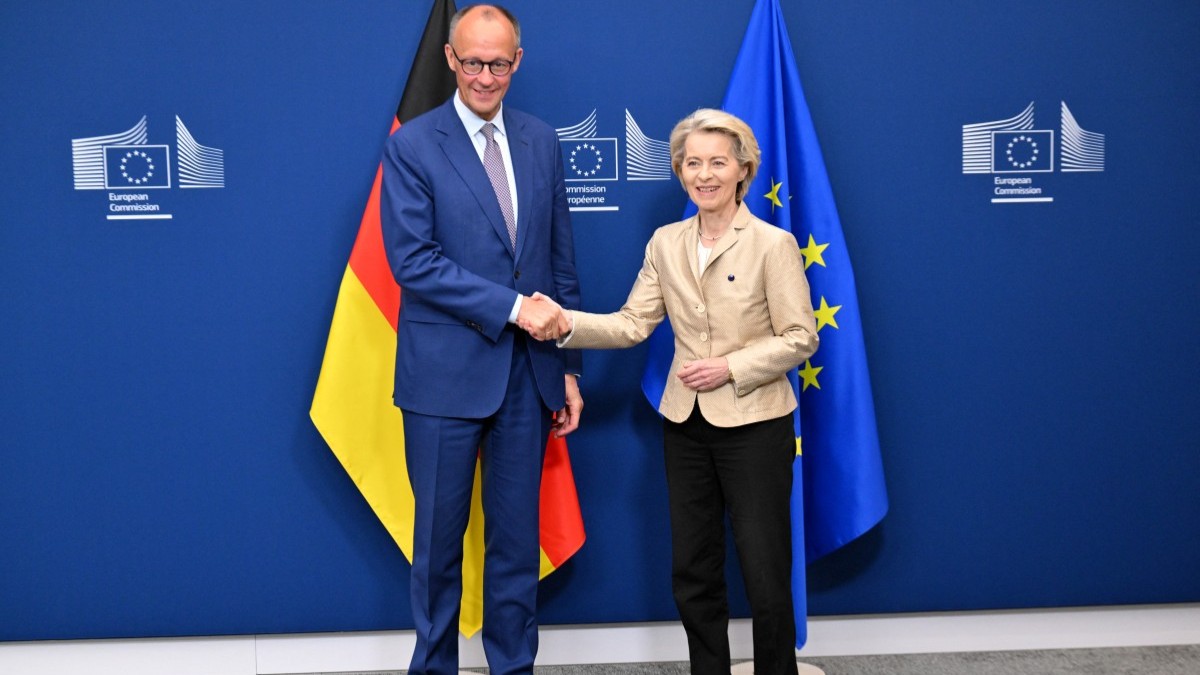 European Commission President Ursula Von der Leyen and German Chancellor Friedrich Merz shake hands prior to a meeting at the EU headquarters in Brussels on May 9, 2025.