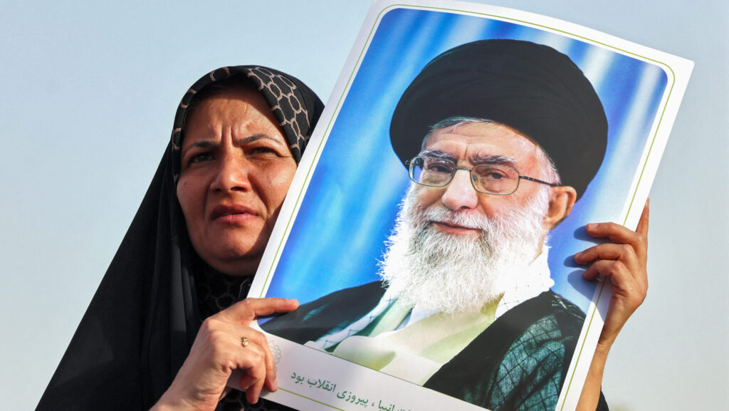 An Iranian woman holds a portrait of supreme leader Ayatollah Ali Khamenei