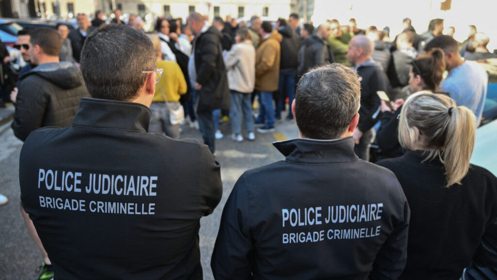 French police officers showing seen from the back with text Police Judiciare Brigade Criminel on back of jackets