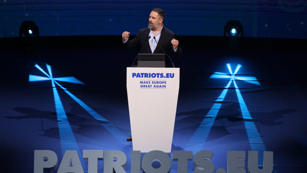 Spanish VOX leader Santiago Abascal speaking from behind podim at Patriots of Europe gathering