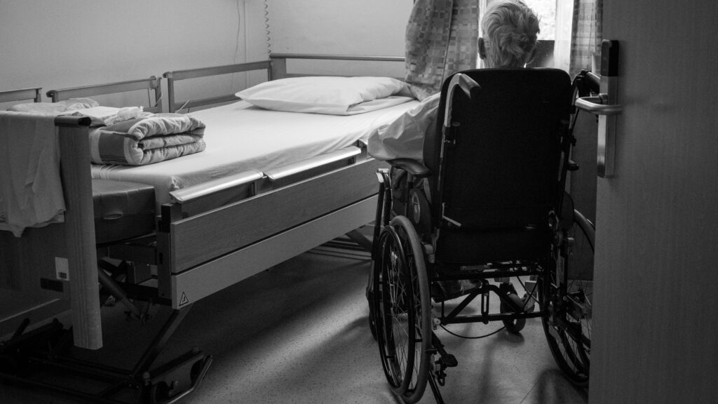 Assisted dying illustration: old person in wheelchair in hospital (Unsplash)
