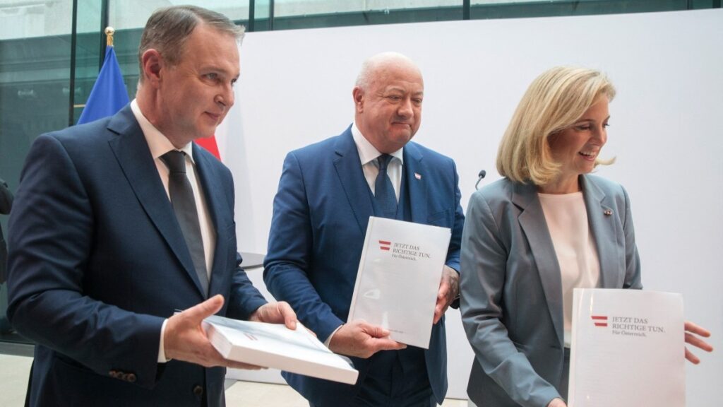 Chairman of the Social Democratic Party of Austria (SPÖ) Andreas Babler, Chairman of the Austrian People's Party (ÖVP) Christian Stocker, and Chairwoman of the liberal Neos Beate Meinl-Reisinger hold copies of their parties' coalition programme at the parliament in Vienna on February 27, 2025.