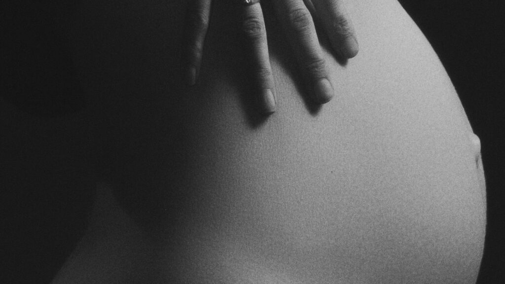 Pregnant woman's belly (Unsplash, cropped)