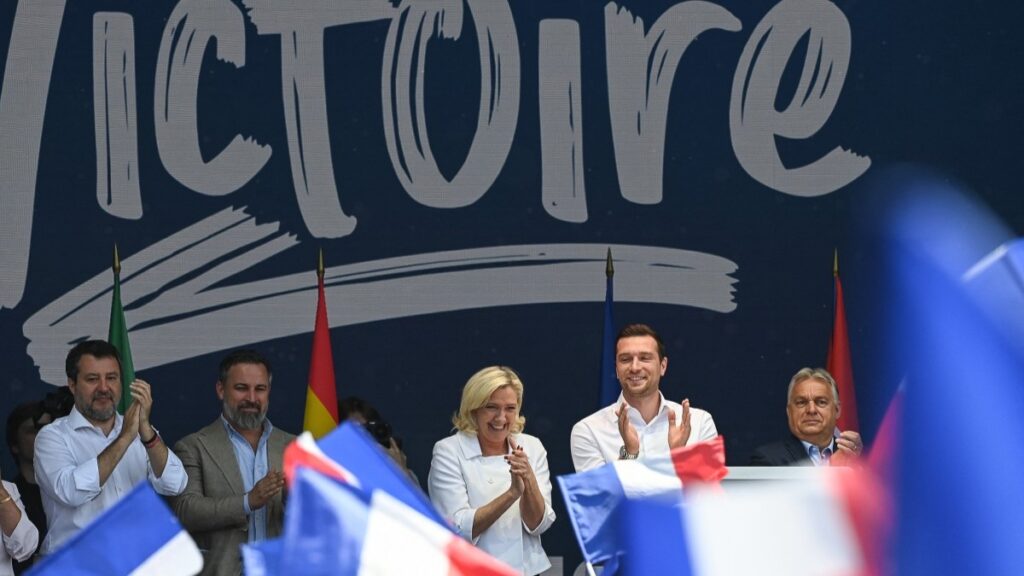Leaders of the Patriots group on stage at the Victory Day rally in France on June 9, 2025