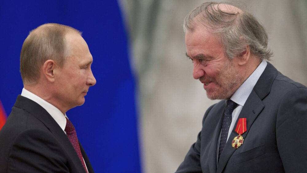 Russian President Vladimir Putin (L) shakes hands with Mariinsky Theatre's Artistic Director, Valery Gergiev