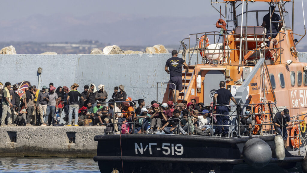 Migrants rescued at sea off the Greek island of Crete disembark in the port of Agia Galini on July 6, 2025