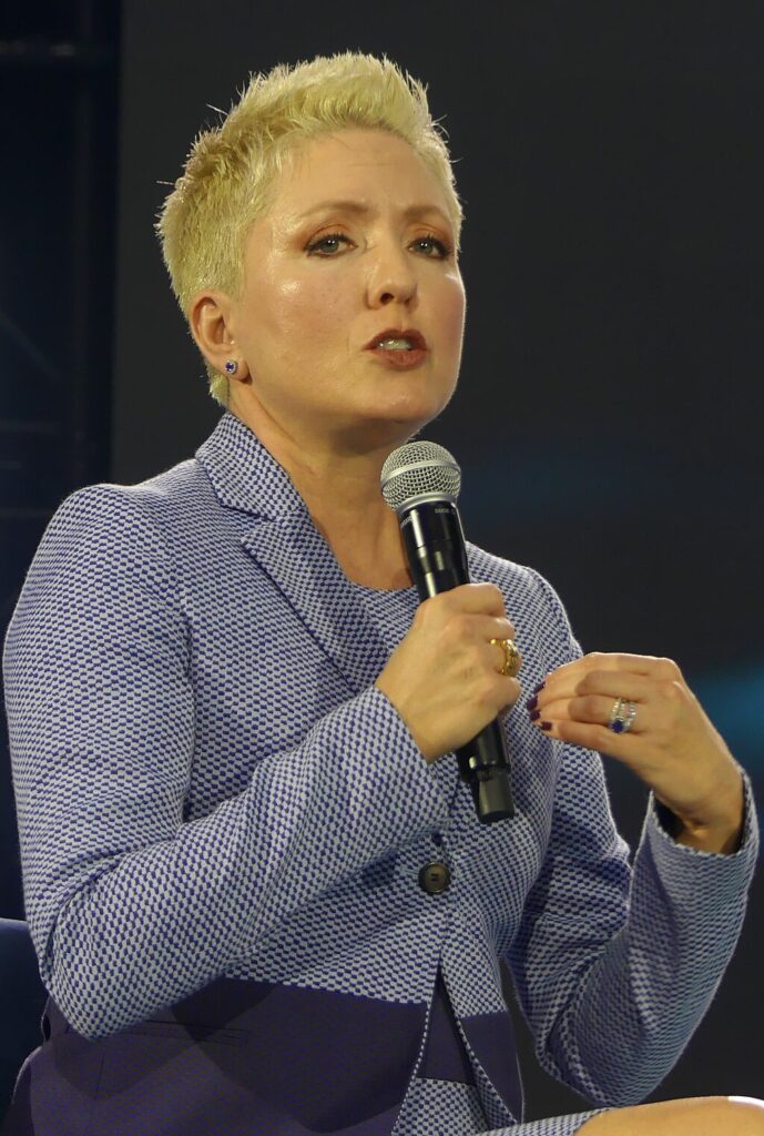 Shea Bradley-Farrell holding a microphone speaking