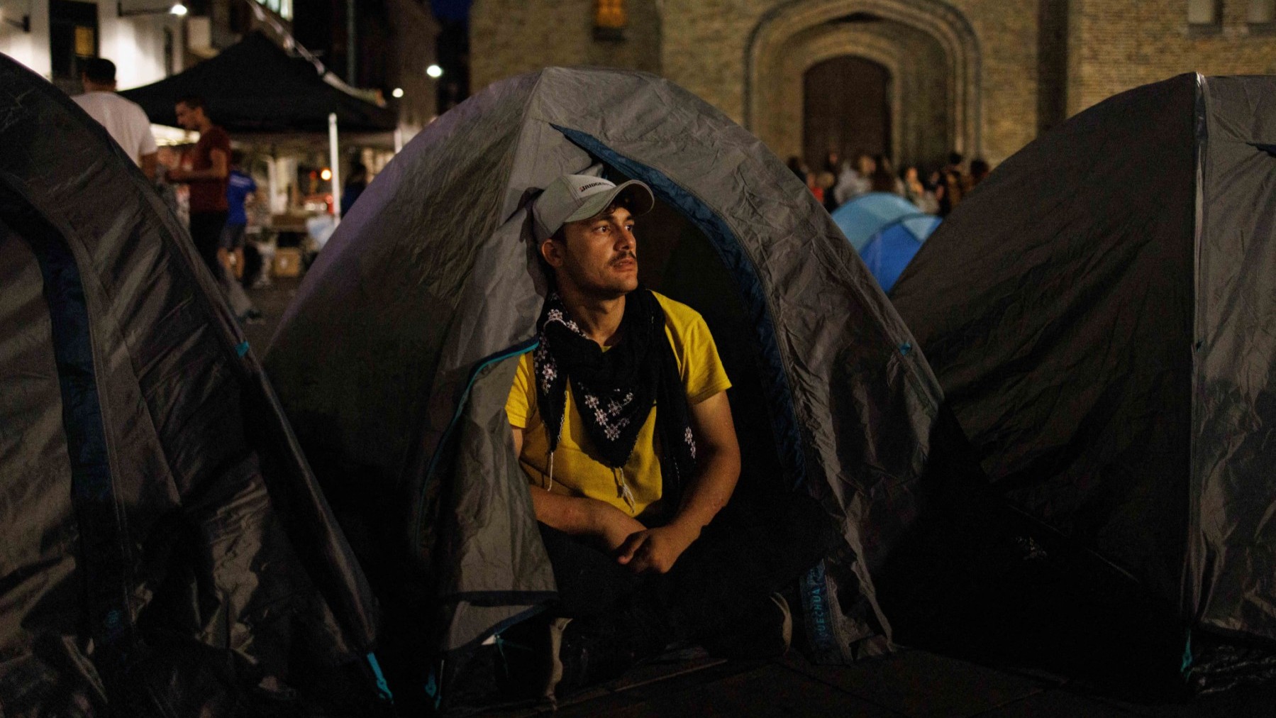 An Afghan asylum seeker sits in front of his tent in Brussels on September 15, 2023.