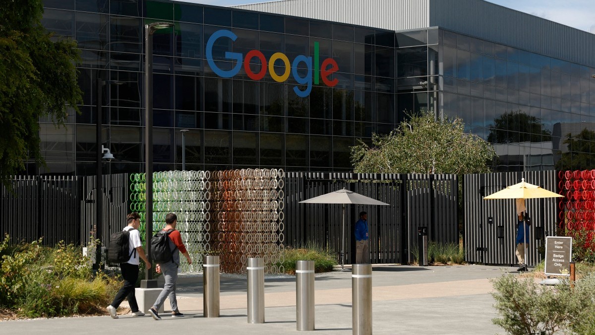 Workers enter a building on the Google headquarters campus on July 23, 2025 in Mountain View, California.