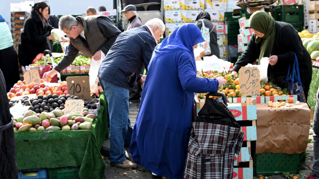 People shopping for fruits and vegetables at a market in Molenbeek, Brussels on October 8, 2024.