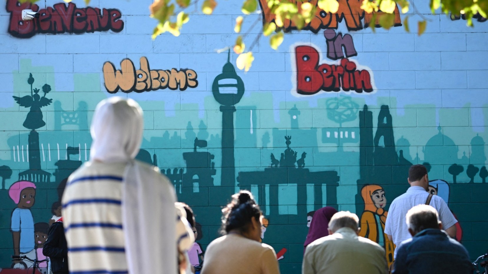 People standing outside an immigration office in Berlin on September 26, 2023.