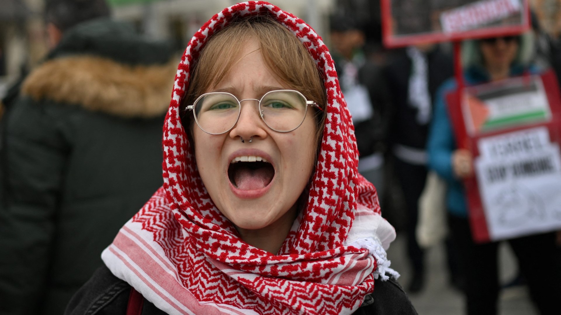A demonstrator wearing a keffiyeh shouting during a pro-Palestinian rally in Warsaw on October 5, 2024, ahead of the first anniversary of the October 7 Hamas attack on Israel.