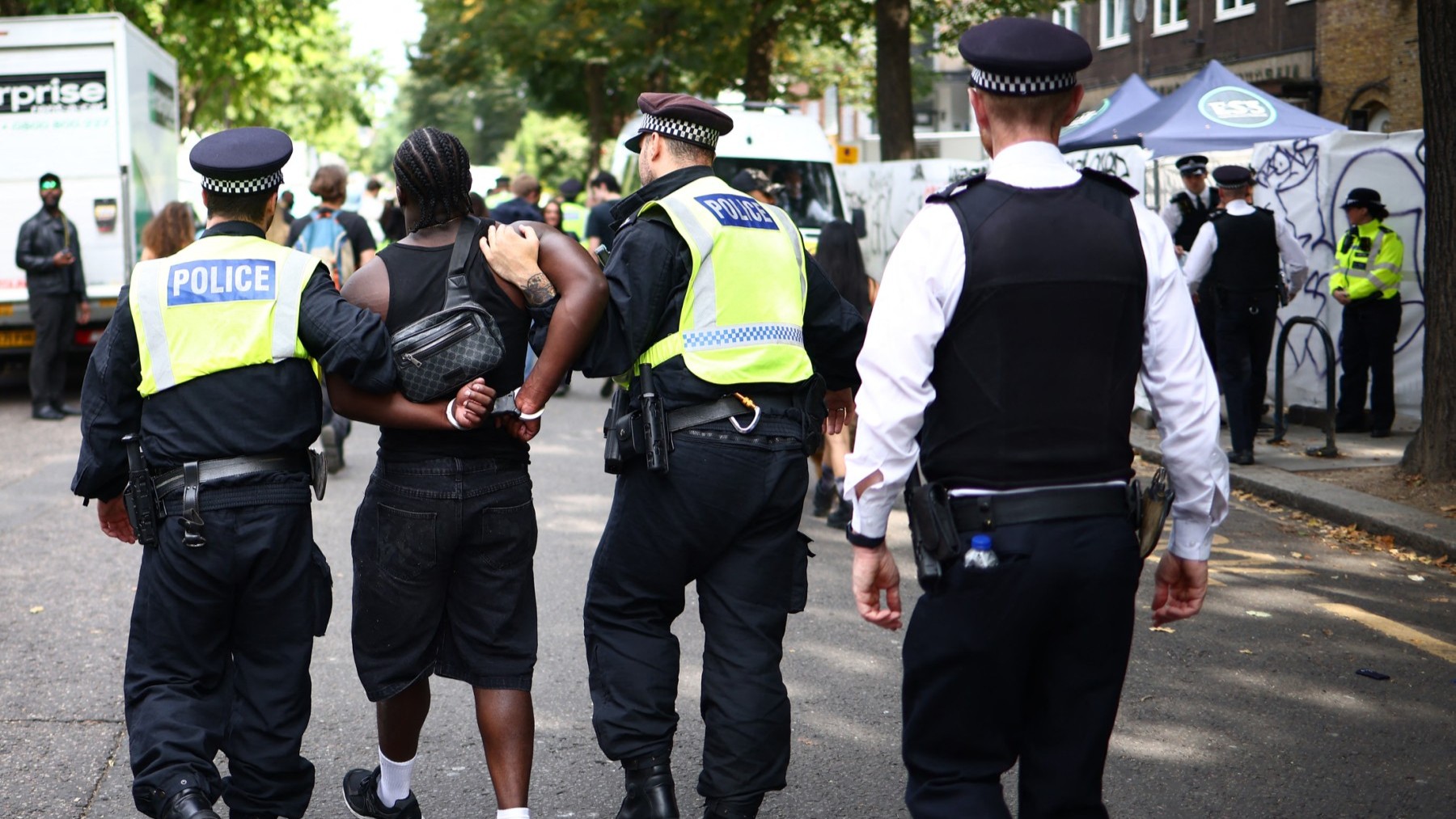 Police officers make an arrest at the Notting Hill Carnival in London on August 26, 2024.
