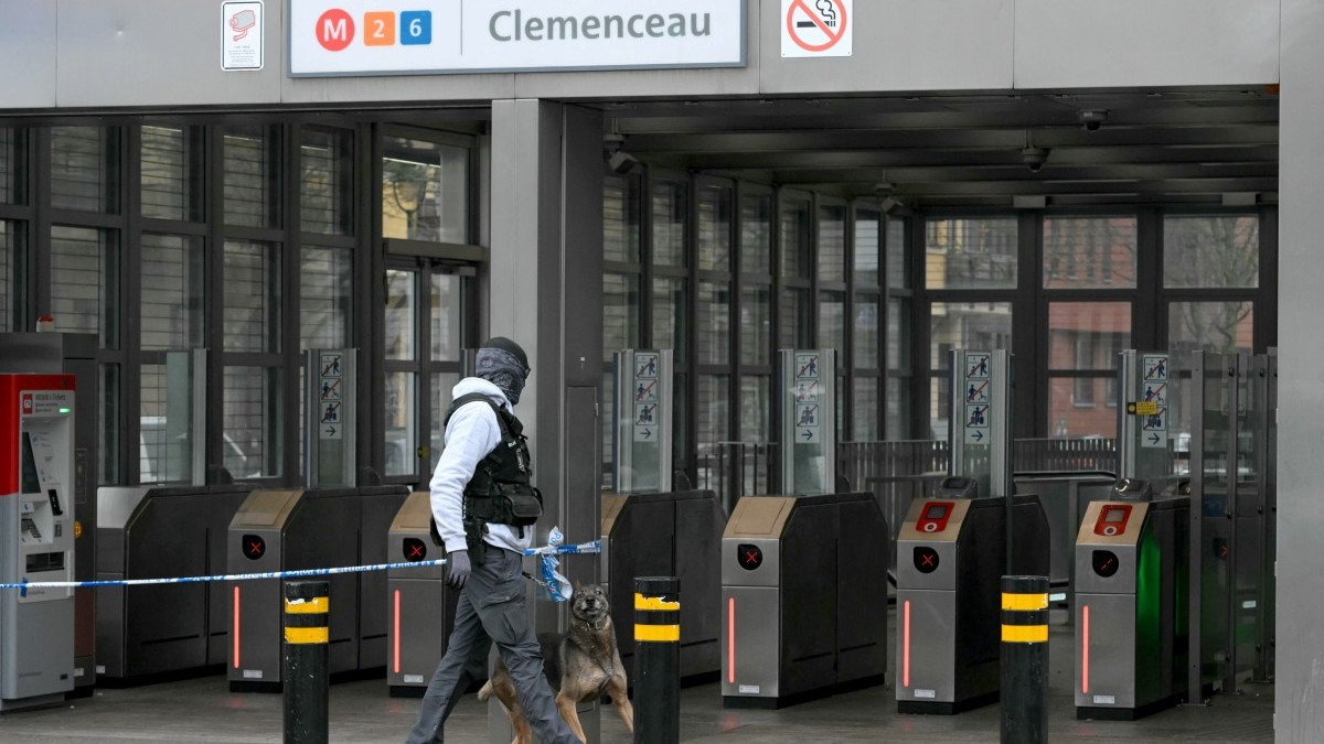 A Belgian security officer and his dog check the entrance of the Clemenceau metro station following a shooting in Brussels on February 5, 2025.