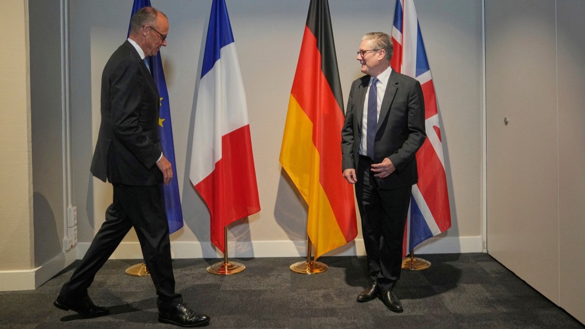 Germany’s Chancellor Friedrich Merz (L) and Britain's Prime Minister Keir Starmer arrive to pose for a picture as they meet on the sidelines of the NATO Summit in The Hague on June 24, 2025.
