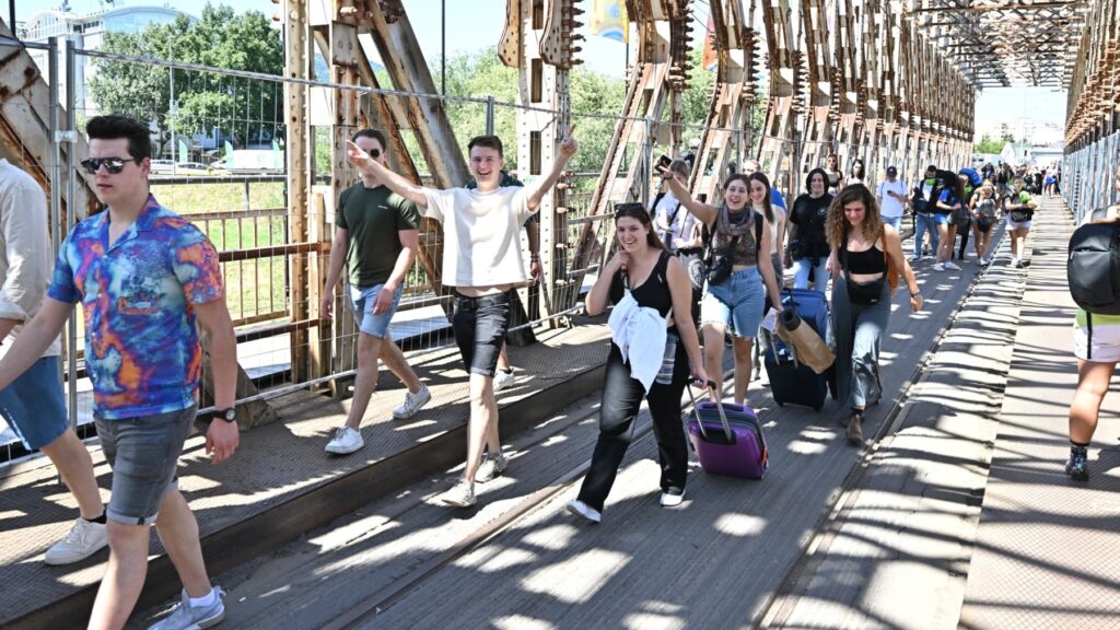 Young participants walking on the main bridge to the island where the Sziget Festival is held on August 10, 2023