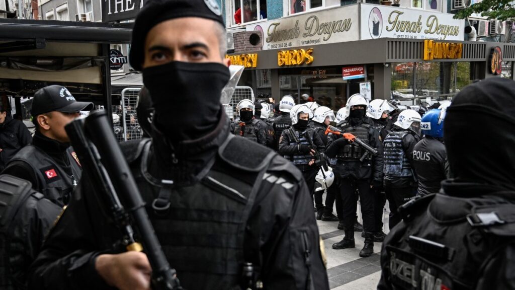 Turkish police stand guard as they stop protesters attempting to march to Taksim Square during a May Day rally in Istanbul on May 1, 2025.