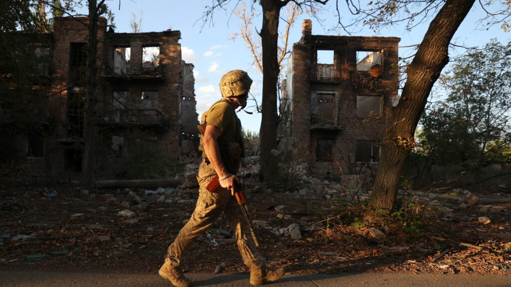 A Ukrainian soldier walks through Chasiv Yar