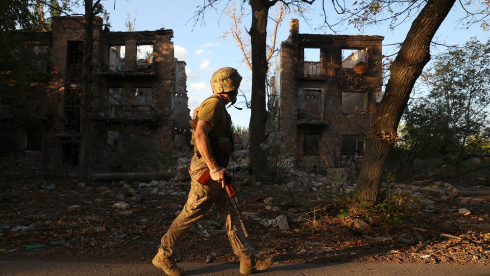 A Ukrainian soldier walks through Chasiv Yar