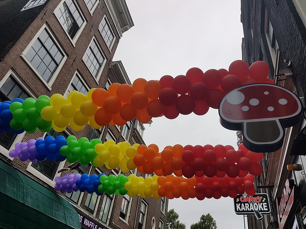 Rainbow-colored balloons hung across street in Amsterdam