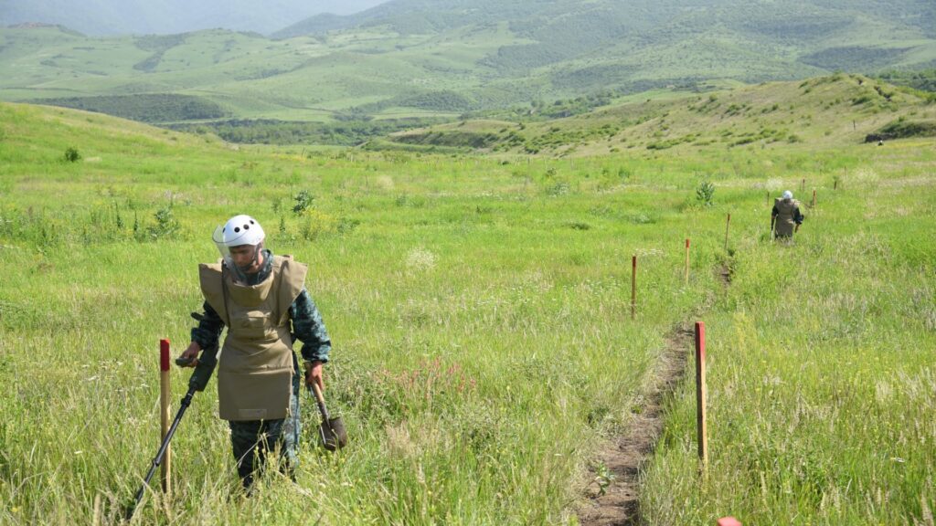 Azerbaijan's sappers inspect an area on May 28, 2024 in the village of Ashaghi Askipara, one of the four villages Armenia returned to Azerbaijani control under a border demarcation deal between the Caucasus rivals.