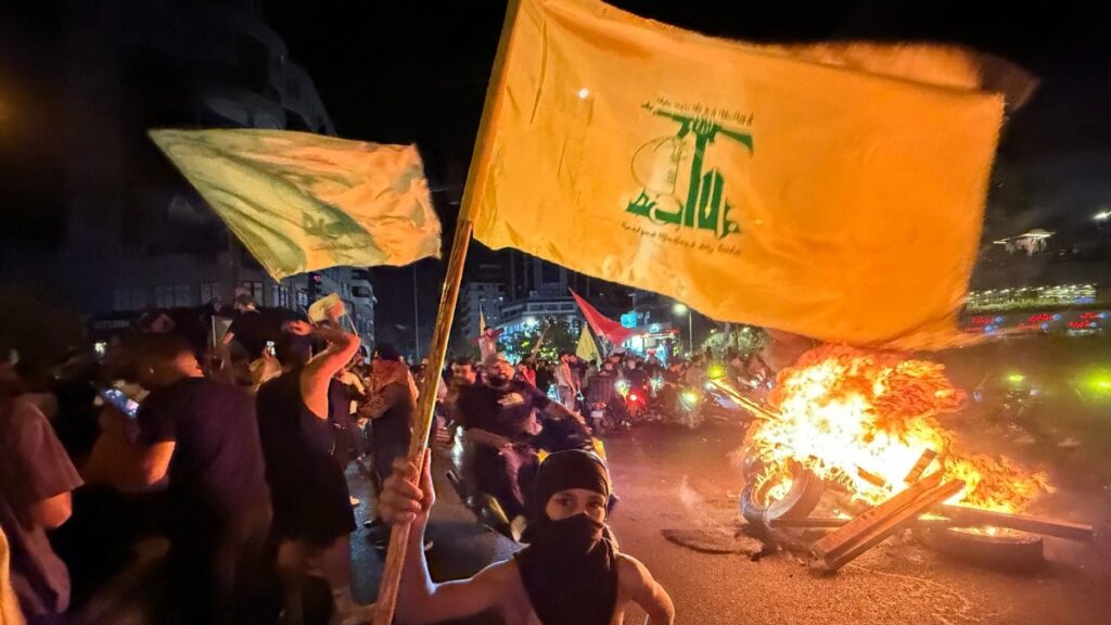 Hezbollah supporters block the streets in Beirut with burning tires as they rally in cars and motorbikes to protest the government decision to disarm it, on August 8, 2025.