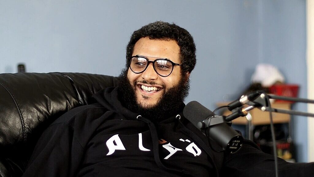 Smiling man in front of microphone
