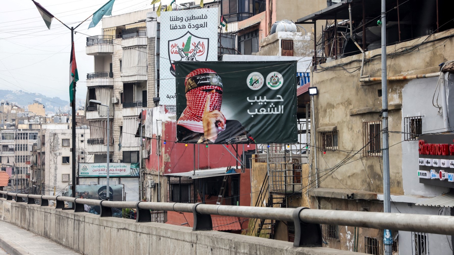 A poster showing Abu Obeida, the spokesman of Hamas' Ezzedine Al-Qassam Brigades, in a street in Beirut on June 21, 2024