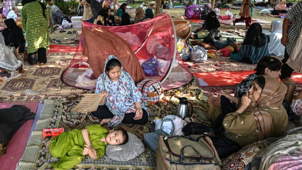 Afghan refugees take shelter at a public park in Islamabad on August 11, 2025.