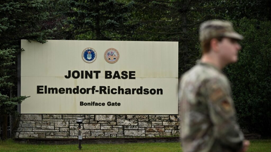 A member of the military stands outside an entrance to Joint Base Elmendorf-Richardson in Anchorage, Alaska, on August 14, 2025, ahead of the August 15 scheduled meeting between U.S. President Donald Trump and Russian President Vladimir Putin.