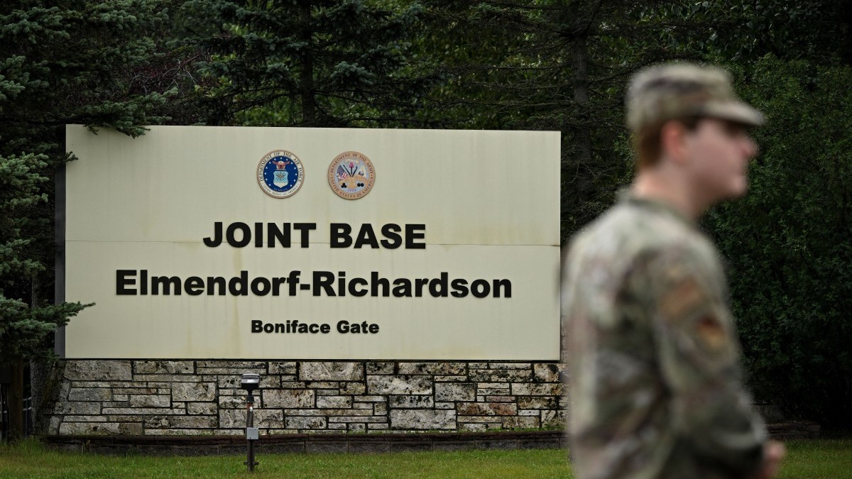 A member of the military stands outside an entrance to Joint Base Elmendorf-Richardson in Anchorage, Alaska, on August 14, 2025, ahead of the August 15 scheduled meeting between U.S. President Donald Trump and Russian President Vladimir Putin.